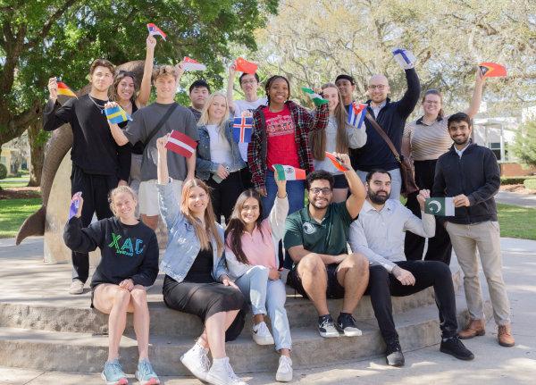 A group of young students signaling the V of victory with their hands